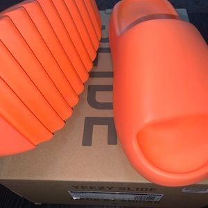 Enflame orange Yeezy slides.